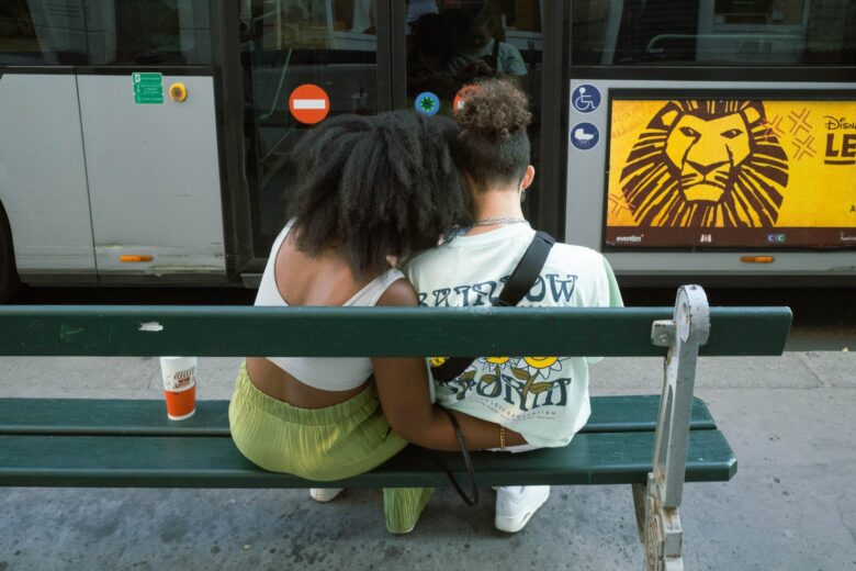 woman hugging man on bench